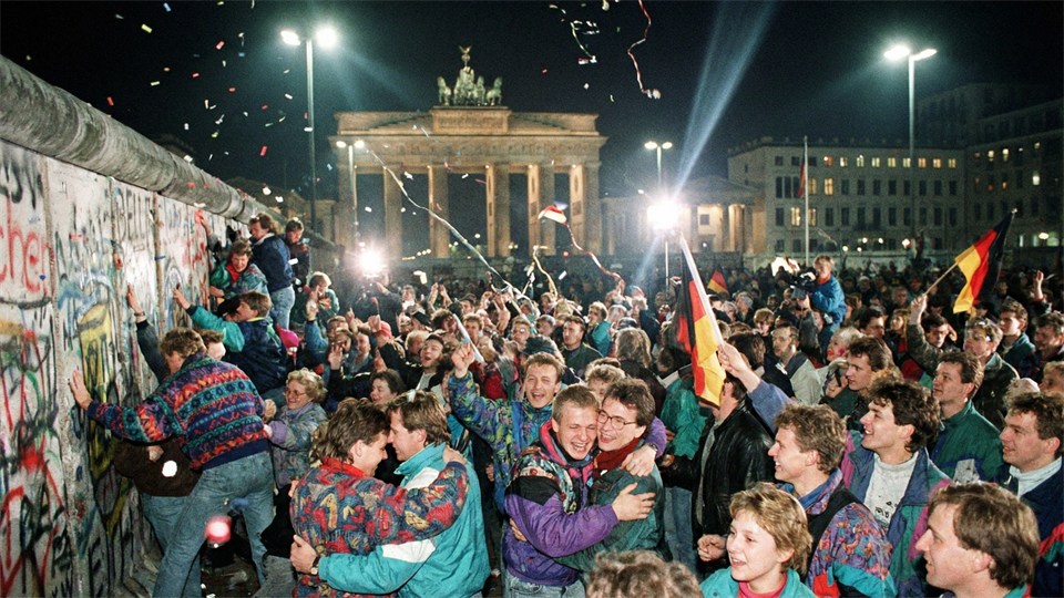 People celebrating the fall of the Berlin Wall in 1989